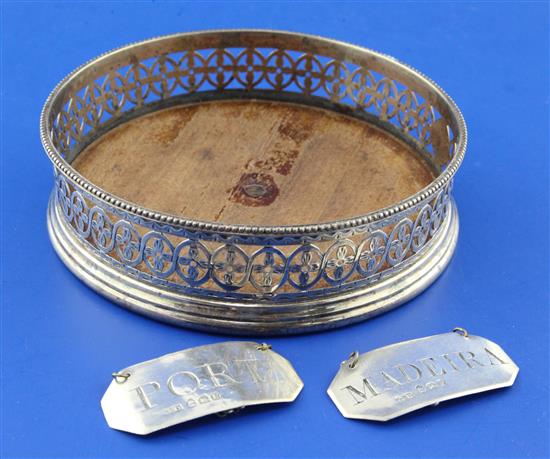 A George III pierced silver wine coaster by Robert Hennell I and pair of wine labels.